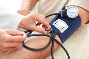 Doctor taking blood pressure measurement