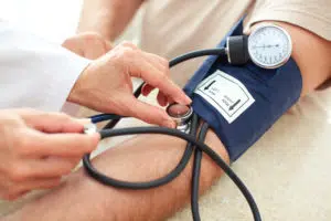 Doctor taking blood pressure measurement