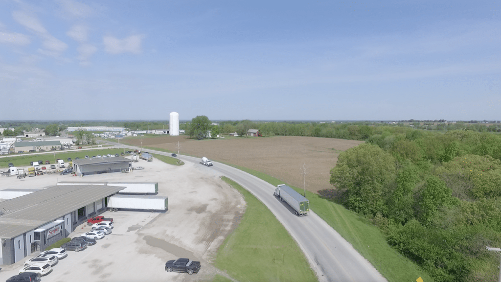 aerial shot of truck leaving lot