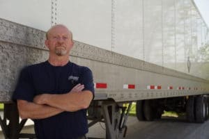 Sisbro driver leans against truck