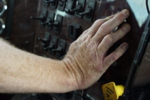 Truck driver's hand on console