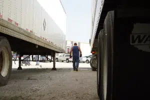 Sisbro truck driver walks around trailer