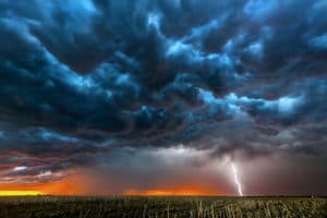 vicious looking storm with lightning over a field